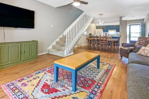 a living room with a couch and a table on a rug at The Pirate Den in Edisto Beach