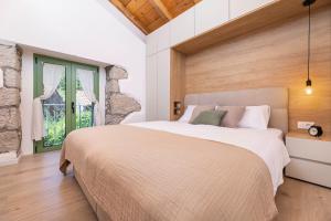 a bedroom with a large bed and a window at Hidden House Porta in Krk +37 photos