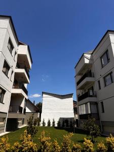 an image of two buildings with a large building at Cozy Central Home & Free Private Parking in Craiova