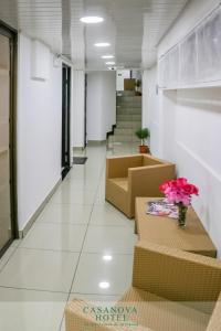 a hallway of an office with boxes and flowers at Hotel Casanova in San José