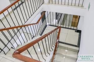 a staircase in a house with white and wooden railings at Hotel Casanova in San José