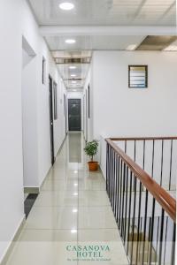 a hallway in an office building with a staircase at Hotel Casanova in San José