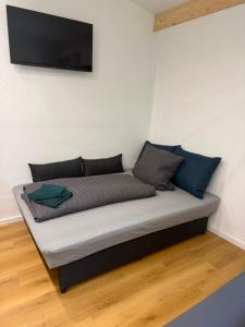 a bed in a room with a tv on a wall at Apartment inn Austria in Pfunds