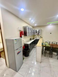 a large kitchen with a table and a refrigerator at شاليهات زارا 3 in Taif
