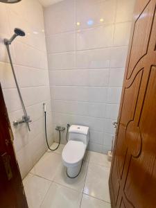 a small bathroom with a toilet and a shower at شاليهات زارا 3 in Taif +8 photos