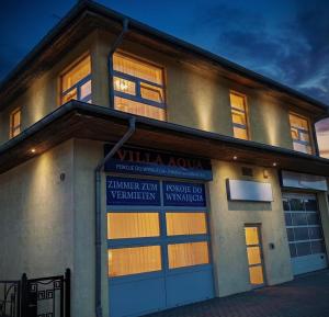 a building with two garage doors in front of it at Villa Aqua in Międzyzdroje