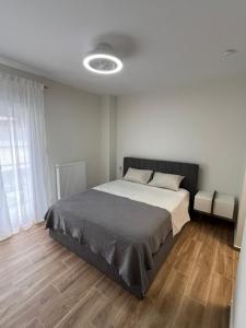 a bedroom with a large bed with a wooden floor at GreveLuxious in Grevena