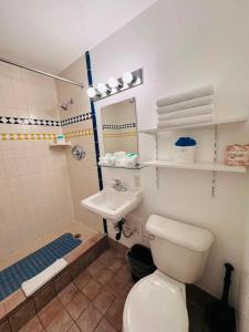 a bathroom with a toilet and a sink at Golden West Motel in Klamath Falls