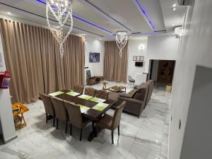 a living room with a table and chairs and a couch at Stylish Abode Guesthouse in Palatswe