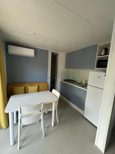 a white table and chairs in a small kitchen at Solle in Banjole