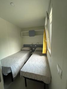 a small room with two beds and a window at Solle in Banjole