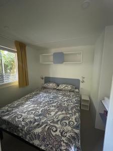 a bedroom with a bed with a comforter on it at Solle in Banjole