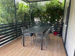 a black table and two chairs on a deck at Solle in Banjole