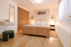a bedroom with a bed and a chair in it at Soba i Apartman Đula in Ogulin