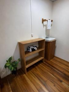 a bathroom with a sink and a wooden floor at House Rio Celeste Paradise in Rio Celeste