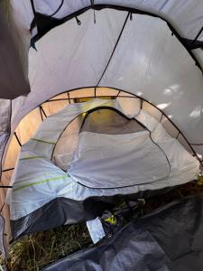 an inside of a tent with the door open at Pey camp in Saubion