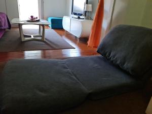 a large couch in a living room with a table at Q tak in Sarajevo