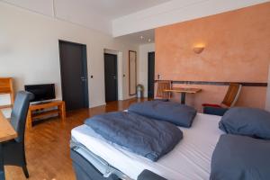 a large bedroom with two beds and a television at Juno Suites Bremen City in Bremen +29 photos