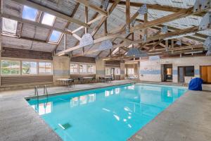 a swimming pool in a building with wooden ceilings at Hotel Nashville in Nashville