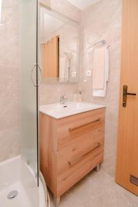 a bathroom with a sink and a mirror at Soba i Apartman Đula in Ogulin +42 photos