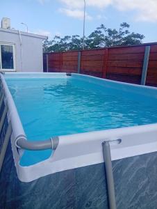 a large swimming pool with a water hose in a house at Rest&breath in Nir Yafe