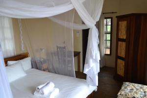 Un pat sau paturi într-o cameră la Tambuti lodge