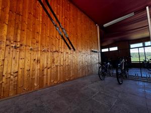 a bike parked in a room with a wooden wall at Apartmán U Medvěda in Vejprty