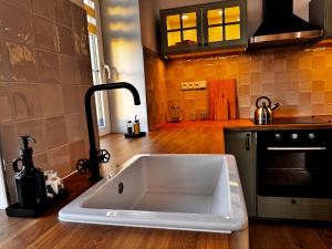 a kitchen with a large white sink in a kitchen at Apartmán U Medvěda in Vejprty +59 photos