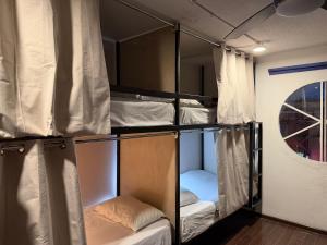 a room with several bunk beds in it at Hostal Vibes in Oaxaca City +48 photos