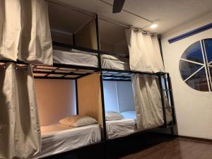 a group of bunk beds in a room at Hostal Vibes in Oaxaca City