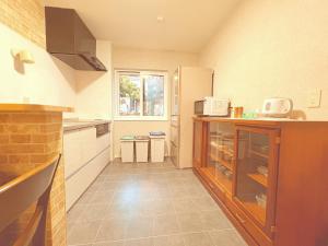 a small kitchen with a counter and a window at Hitori Otaru in Otaru