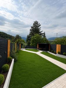 a garden with green grass and a fence at Dilijan House in Dilijan +27 photos