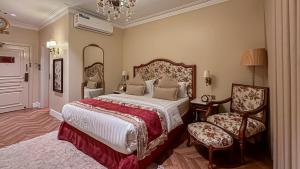 a bedroom with a large bed and a chair at The Classic Palace in Abha +92 photos