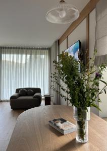 a living room with a vase of flowers on a table at Chaty Gorcovia in Nowy Targ
