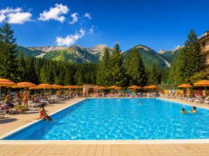 a pool at a resort with mountains in the background at RESIDENCE ALTAIR Via Roma 13 in Ovindoli