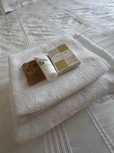 a pile of towels sitting on top of a bed at Apartman Simikic in Lopare