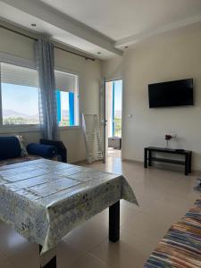 a living room with a table and a tv at Alta-Home cabo in Cabo Negro