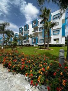 a field of flowers in front of a building at Alta-Home cabo in Cabo Negro