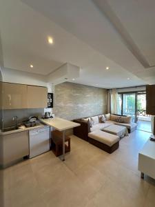 a kitchen and living room with a couch and a table at Excelente apartamento en Cabo beach in Cabo Negro +252 photos