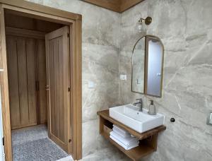 a bathroom with a sink and a mirror at Chaty Gorcovia in Nowy Targ +23 photos