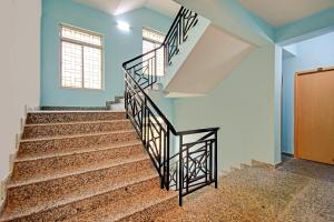 a staircase in a house with blue walls and a window at Hotel O Casa Astra in Salua