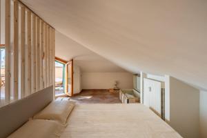 a living room with a couch and a staircase at Maison Blanche in Bordighera