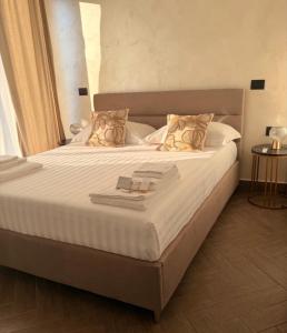 a bedroom with a large bed with white sheets and pillows at Villa Sidoti in Calatabiano +18 photos