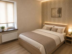 ein Schlafzimmer mit einem großen Bett und einem Fenster in der Unterkunft Шариф in Sumy