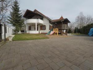 a house with a playground in front of it at Napsütötte Kehida in Kehidakustány