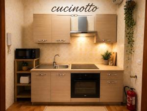 a kitchen with a sink and a stove top oven at RESIDENCE ALTAIR Via Roma 13 in Ovindoli