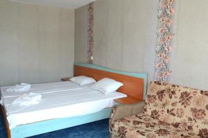 a bed and a chair in a room at Hotel Kristel Park - All Inclusive Light in Kranevo
