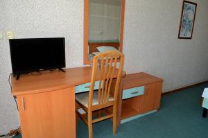 a wooden desk with a computer monitor and a chair at Hotel Kristel Park - All Inclusive Light in Kranevo +81 photos