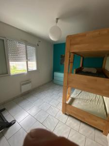 a bedroom with two bunk beds in a room at Villa Cazaux in La Teste-de-Buch