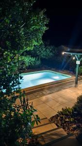 a swimming pool in a yard at night at Cozy studio in medieval town in Le Val